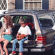 Family around station wagon.